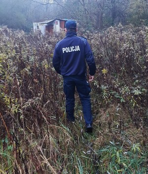 policjant prewencji idący w kierunku pustostanu - z