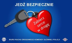 plakat - serce z napisem Zabierz serce w drogę, za sercem jest kluczyk do samochodu oraz brelok. Nad sercem i kluczykiem znajduje się napis Jedź bezpiecznie.