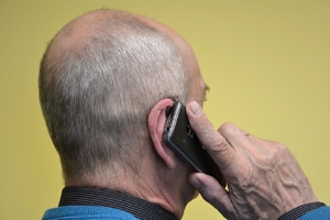 starszy mężczyzna rozmawiający przez telefon komórkowy