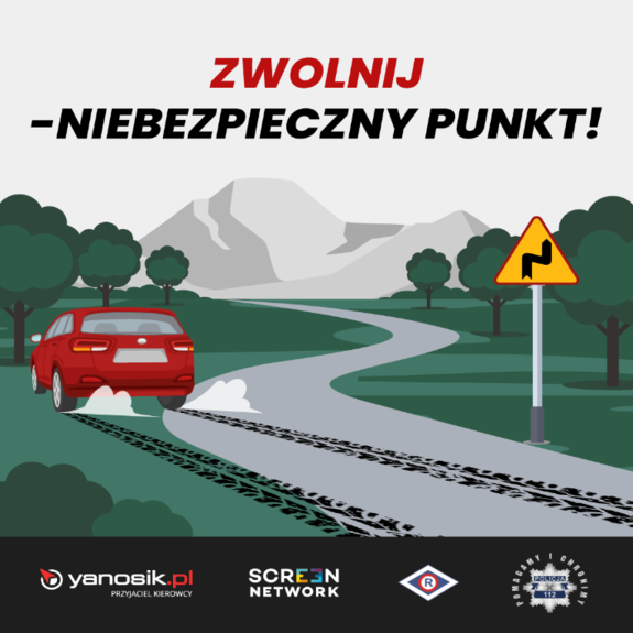 napis zwolnij - niebezpieczny punkt, grafika z samochodem zjeżdżającym z drogi