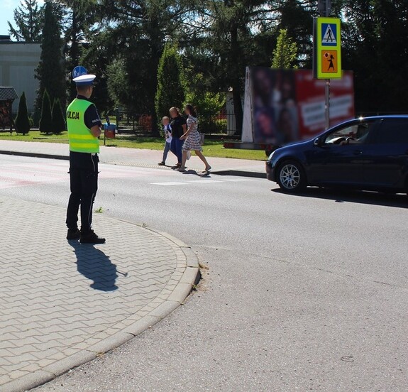 rejon przejścia dla pieszych przy szkole,  policjant, piesi przechodzący na drugą stronę jezdni - fot. arch. KMP NS — kopia