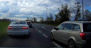 4. audi zatrzymuje się, przed nim ford, za nim nim samochód policjanta i obok opel
