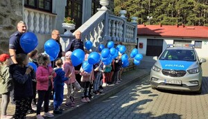 przedszkolaki oraz policjanci przed budynkiem komisariatu w Piwnicznej-Zdroju