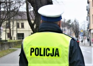 policjant ruchu drogowego w żółtej kamizelce z napisem POLICJA