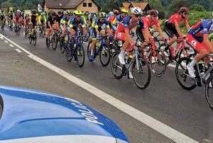 kolarze przejeżdżający obok radiowozu - zdjęcie archiwalne KMP w N. Sączu