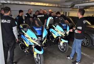 20. EGIDA-22 KMP w Nowym Sączu - uczestnicy ćwiczeń przyglądają się z bliska motocyklom służbowym ruchu drogowego zaparkowanym w podziemnym garażu komendy