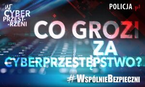 Napis co grozi za cyberprzestępstwo, w tle klawiatura komputera
