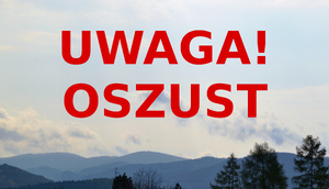 Czerwony napis Uwaga oszust, w tle góry