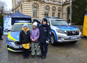 policjantka i dwie dziewczynki przy radiowozie