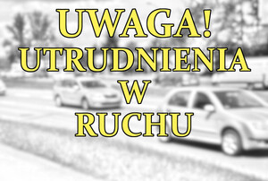 napis uwaga utrudnienia w ruchu, w tle jadące samochody